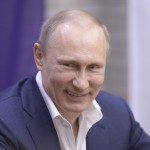 Russian President Vladimir Putin smiles as he celebrates International Women's Day in Sochi